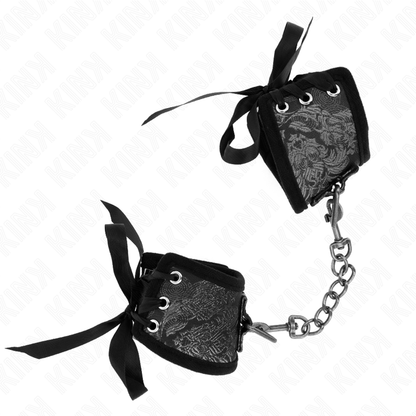 KINK - SCANDAL HANDGELENKFESSELN SCHWARZE SPITZENDETAILS 24,5 CM X 6,5 CM